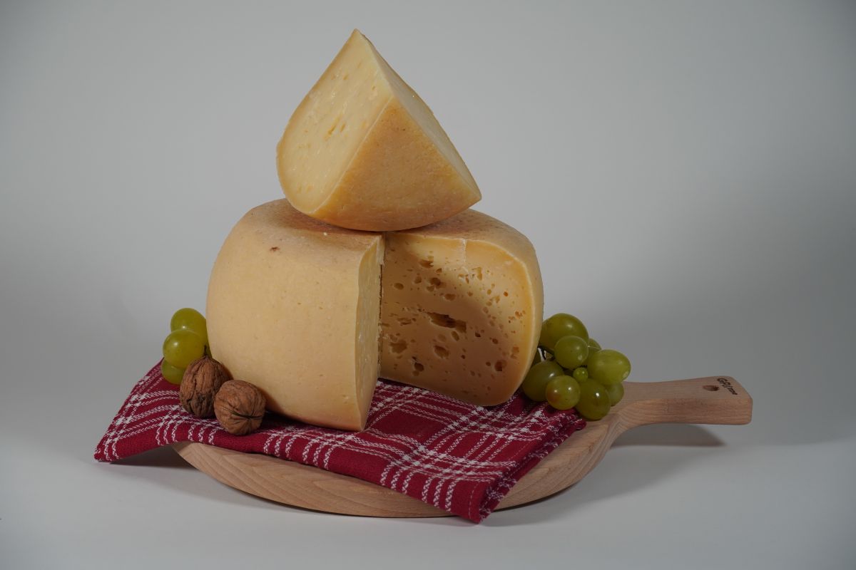 Formaggio su tagliere di legno e panno da cucina